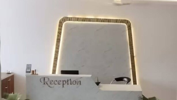 A reception desk with a sign that reads "Reception" and a modern, minimalist design. - Hotel Lakeview Chhatarpur (Chhatarpur)