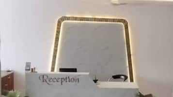 A reception desk with a sign that reads "Reception" and a modern, minimalist design.