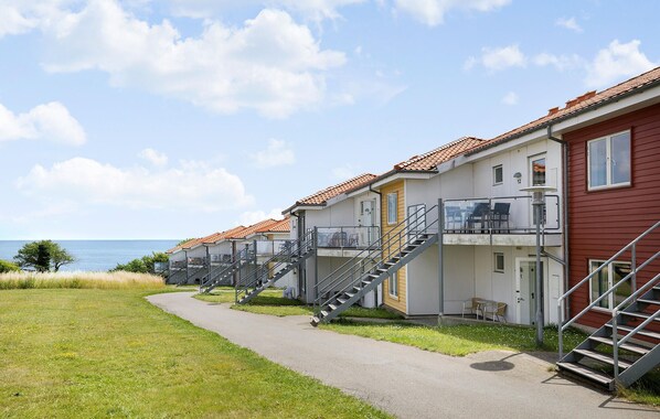 Accommodations offer balconies with stairs leading to a seating area overlooking the sea.