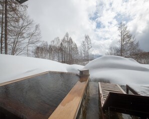 A hot spring area with wooden benches and a wooden platform.