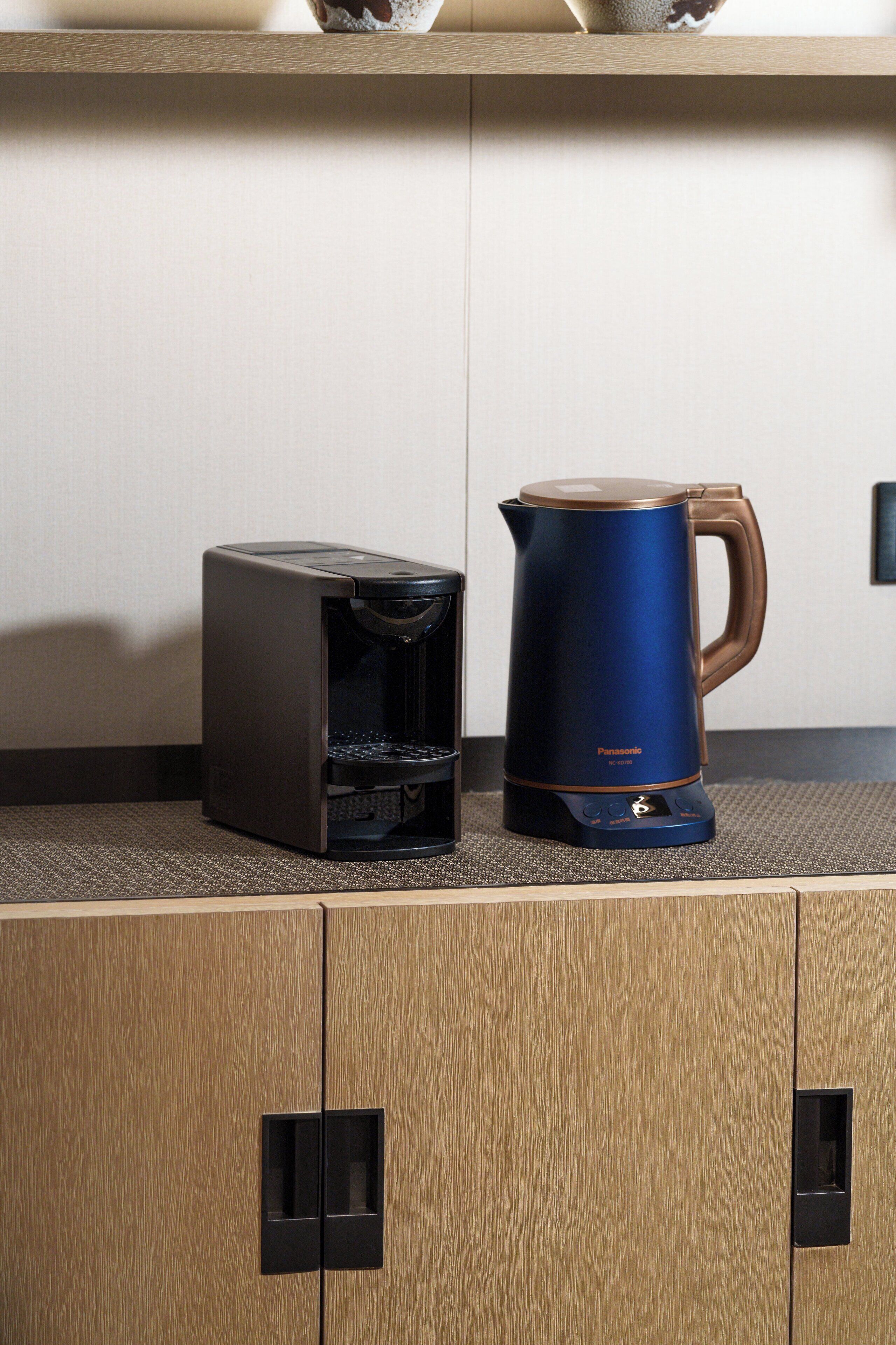 A coffee maker and a kettle on a countertop.