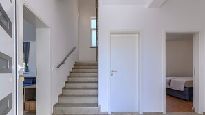 A staircase leading to a bedroom with a bed and a window. - Vacation home Kliska by Interhome (Pula)