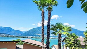 A residential area with a view of a lake and mountains.