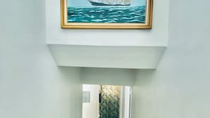 A staircase leading to a room with a view of the sea.