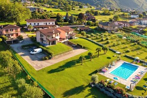 A residential area with houses, a swimming pool, and a driveway.