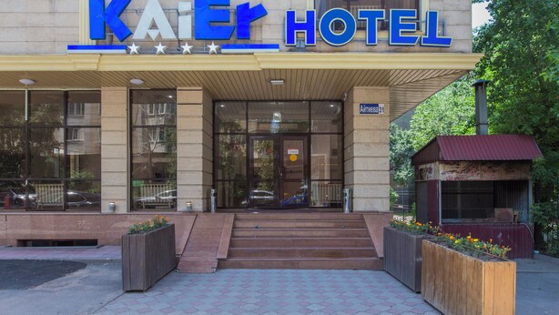 The exterior of the Kai Hotel with a clear entrance, steps leading up to the doors, and a sign above the entrance.
