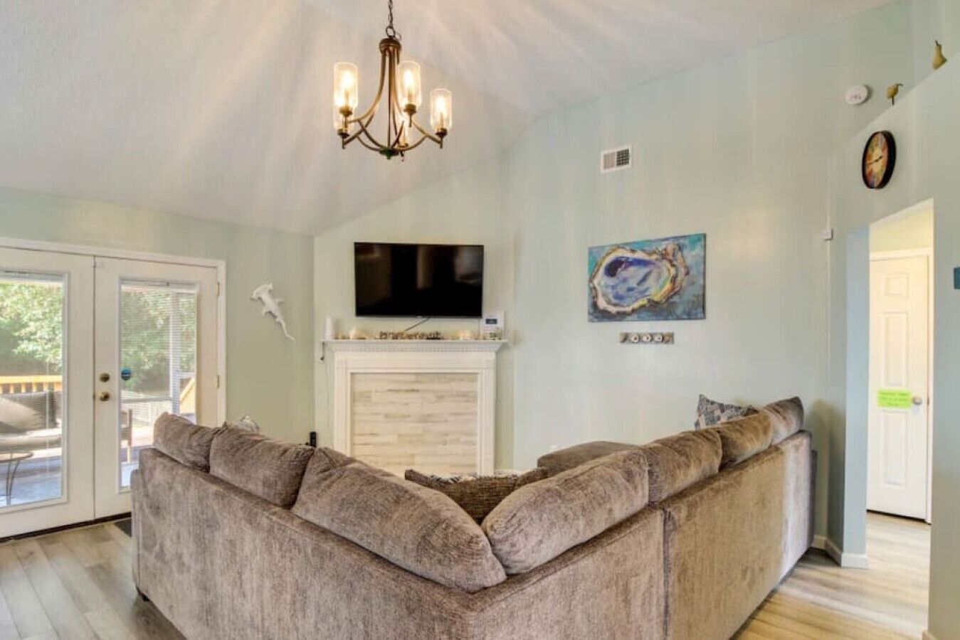 Inviting living room featuring a blend of modern design and beach-inspired decor, perfect for relaxation and entertaining.