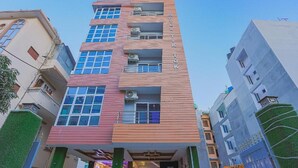 A multi-story hotel with a modern facade, balconies, and air conditioning units. - Hotel Tiktok (Kathmandu)