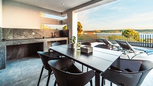 A modern outdoor dining area with a view of the countryside. - Lovely home in Razanac (Razanac)