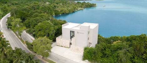 A modern building with a flat roof and a sign reading "AMARANTO."