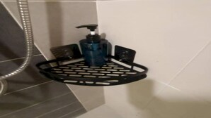 A bathroom with a black soap dispenser on a black tray stand. - SPOT ON 91018 Sunshine Bnb Concept Service (Ipoh)