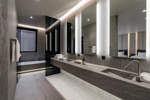 A modern bathroom with a long vanity, a large mirror, and a bathtub. - Daegu Suseong The Arco Hotel Lions Park (Daegu)