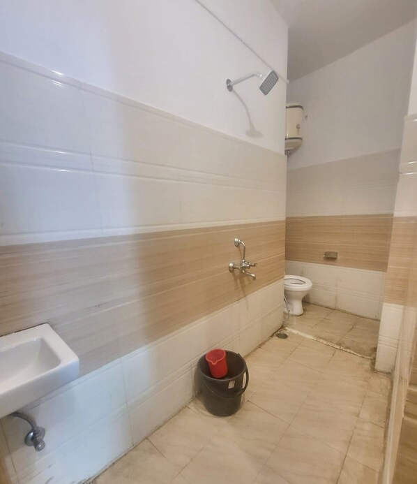 A bathroom with a sink, toilet, and shower. - Abodes Elegant Hills (Dehradun)