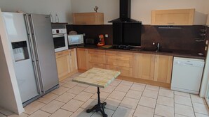 A compact kitchen with a refrigerator, oven, microwave, and dishwasher.
