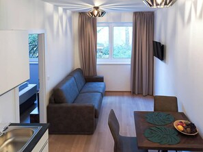 Apartamento, 1 cama Queen e sofá-cama, para não fumantes | Área de estar