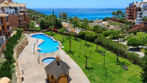 A resort with a large swimming pool, a small hut, and a view of the ocean. - Ático Galera Playa Free Padel by Interhome (Almuñécar)