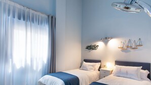 A bedroom with two beds, a window with sheer curtains, a wall-mounted light fixture, and a decorative wall art piece. - Ático Galera Playa Free Padel by Interhome (Almuñécar)