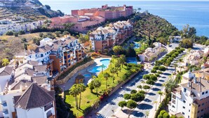 A coastal resort with multiple buildings, a swimming pool, and a view of the sea. - Ático Galera Playa Free Padel by Interhome (Almuñécar)