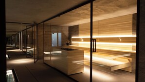 A modern interior with glass partitions, wooden paneling, and a bench. - No.14 Verbier (Bagnes)