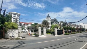 A gated entrance to a hotel with a prominent tower and a sign reading "DANTEINO HOTEL & RESORTS." - Stay in Unit 301 Pontefino Tower, a Cozy 1 Bedroom Apartment that is Brand New (Batangas)