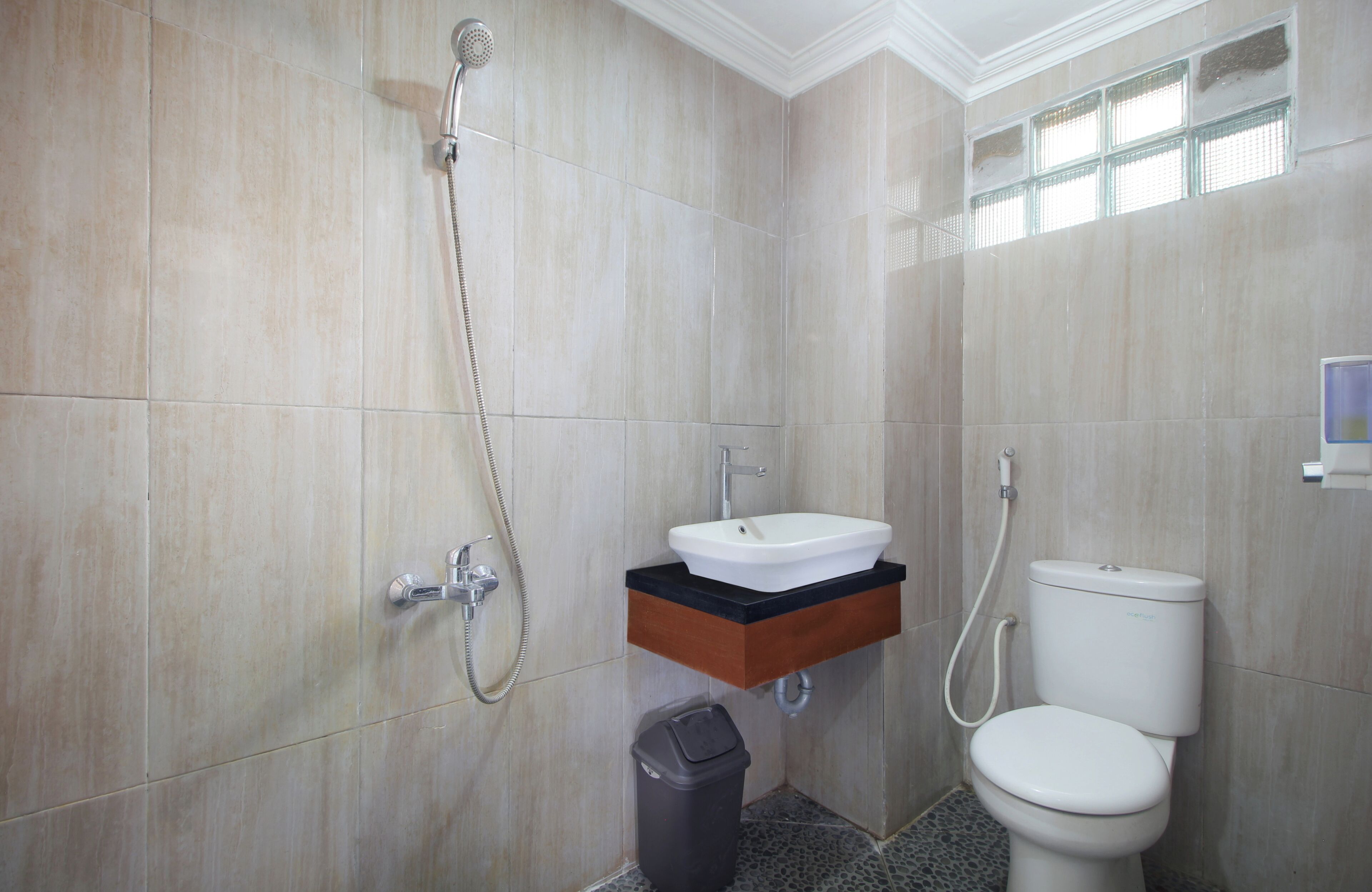 A bathroom with a sink, toilet, and shower.