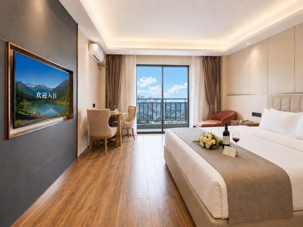 A hotel room with a bed, a desk, a chair, a TV, and a balcony with a city view. - Bole Boutique Hotel, Sihanoukville (Sihanoukville)