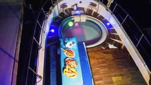 A pool area with a blue deck, lounge chairs, and a hot tub. - AMAZING in Ortigia  (Siracusa)