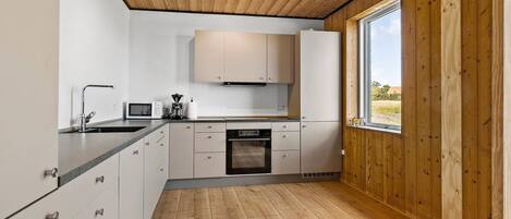 Fridge, stovetop, dishwasher, coffee/tea maker