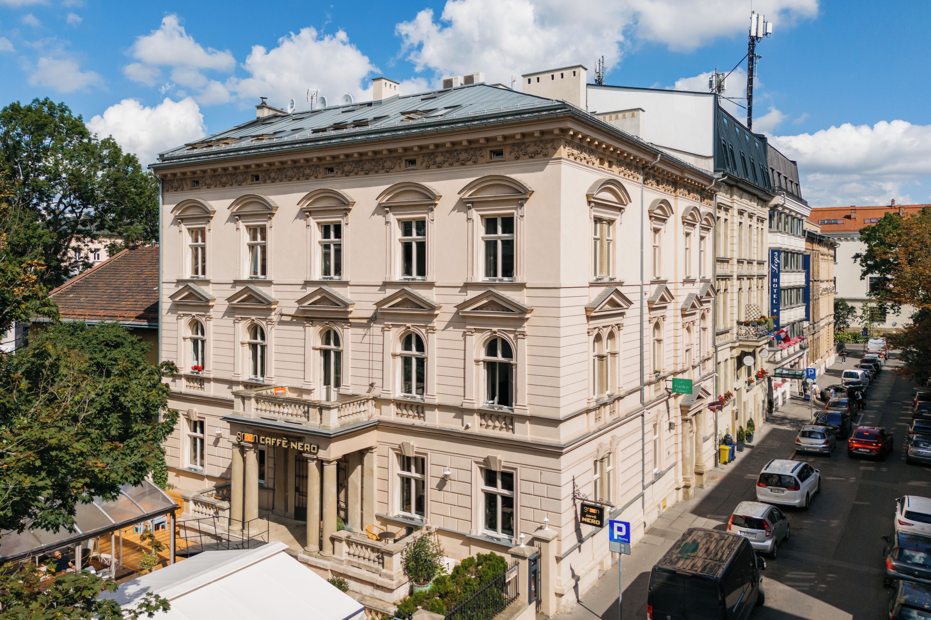 A historic building with a classical facade, multiple windows, and a ground-level entrance.