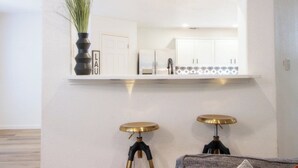 A modern kitchen with white cabinets, a built-in oven, and a countertop.