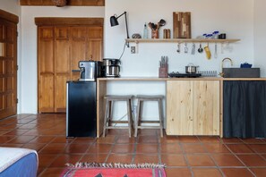 Compact kitchen with sink and stove, perfect for cooking and dining.