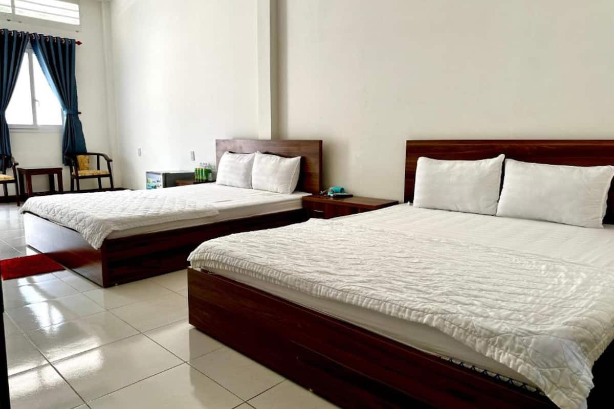 Two single beds with wooden headboards in a hotel room.