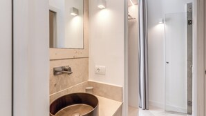 A modern bathroom with a large mirror, a wooden basin, a towel rack, and a glass shower enclosure. - Diff'rent Souls Rooms (Sorrento)