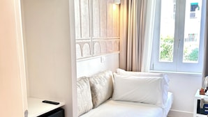 A bedroom with a bed, a wardrobe, a television, and a window with curtains. - Diff'rent Souls Rooms (Sorrento)