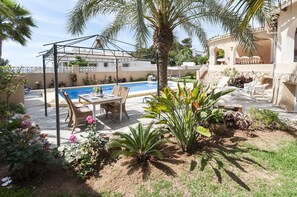A pool area with a pergola, outdoor seating, and a palm tree. - Frederic in Balc n del Mar (Javea)
