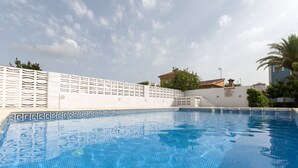 A swimming pool with a tiled deck and a white fence. - Golden in Gandia With 3 Bedrooms and 3 Bathrooms (Gandia)
