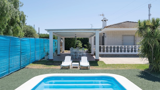 A swimming pool with lounge chairs and a covered patio area. - Fuentes Del Colorao in Barrio Nuevo (Conil de la Frontera)
