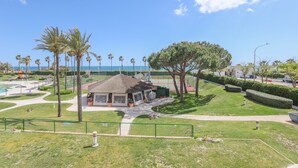 A park with a gazebo, palm trees, and a view of the sea. - Las Americas in Islantilla (Isla Cristina)