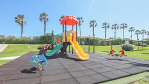 A playground with various play structures including slides and swings. - Las Americas in Islantilla (Isla Cristina)