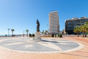 A public square with a central statue, palm trees, and a tall building with "Stelle Meridien" signage. - Montealba in Costa del Sol (Fuengirola)