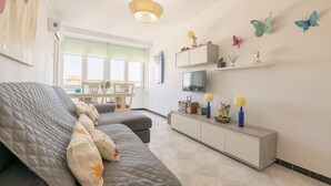A modern living room with a grey sofa, a white cabinet, and butterfly wall art. - La Ma a in San Fernando (San Fernando)