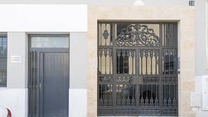 A building facade with a dark wooden door and ornate metal window grills. - La Ma a in San Fernando (San Fernando)