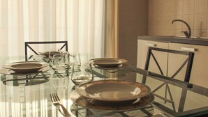 A dining table set with plates, glasses, and cutlery. - [Exclusive 120 SQM] in the heart of Bergamo (Bergamo)