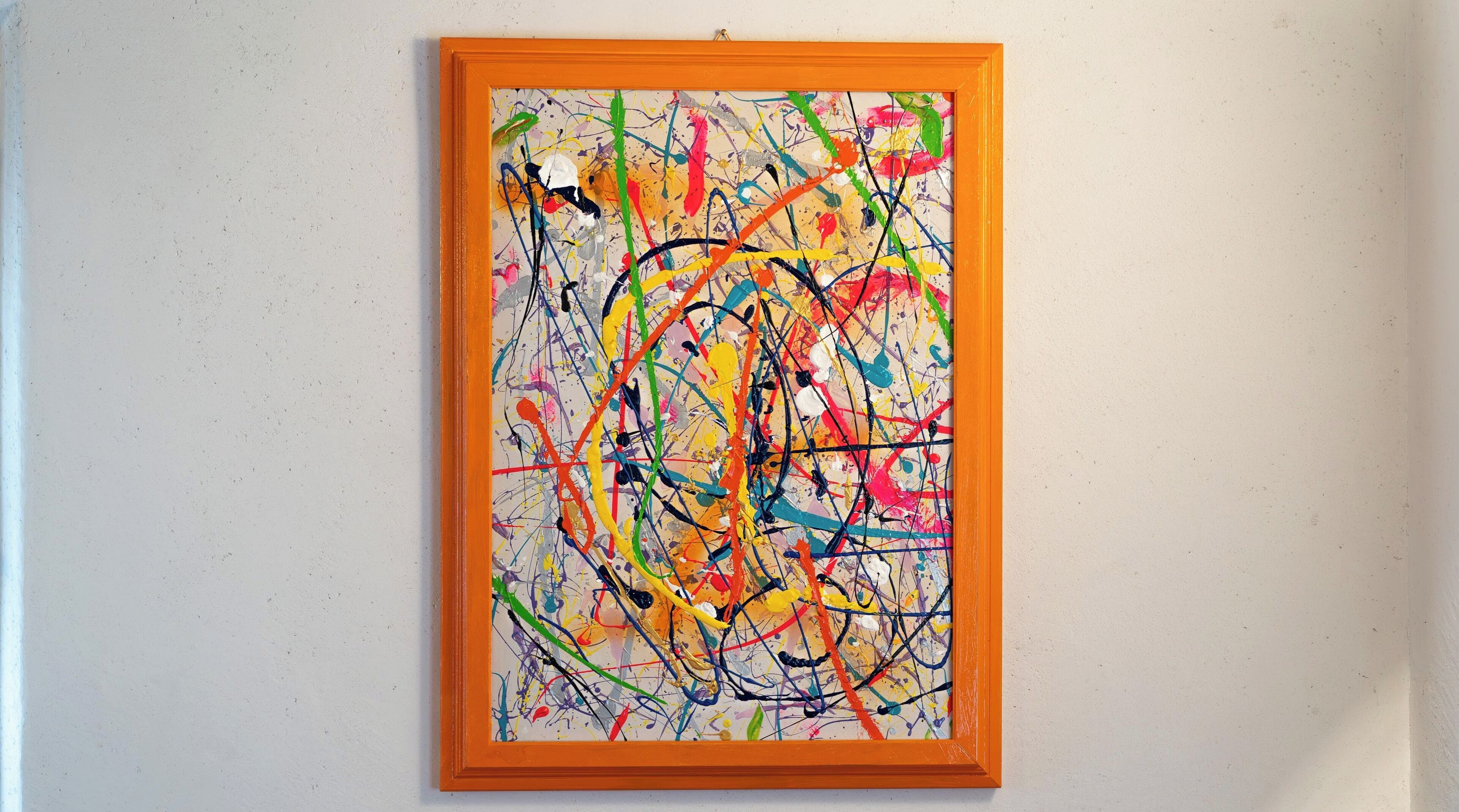 A framed abstract painting with a textured background.
