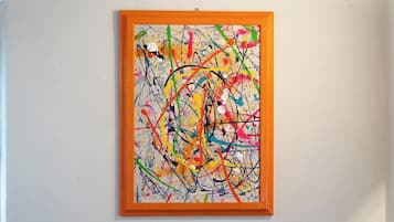 A framed abstract painting with a textured background.