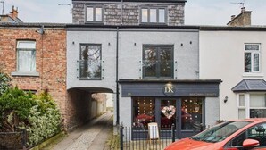 A two-story building with a ground-level hair salon and a second-floor residential unit. - Host Stay Roseberry Topping Townhouse (Middlesbrough)