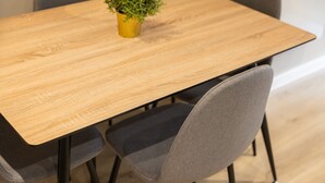 A wooden dining table with four grey upholstered chairs. - Host Stay Richmond Place 102 (Liverpool)