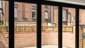 A room with large sliding glass doors leading to an outdoor brick patio.