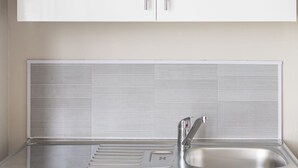 A modern kitchen with stainless steel appliances, a double sink, and white cabinetry. - Host Stay Clifton Studio 5 (Darlington)