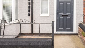 A house with a dark front door, a small window above the door, and a white-framed window to the left. - Host Stay Clifton Studio 5 (Darlington)